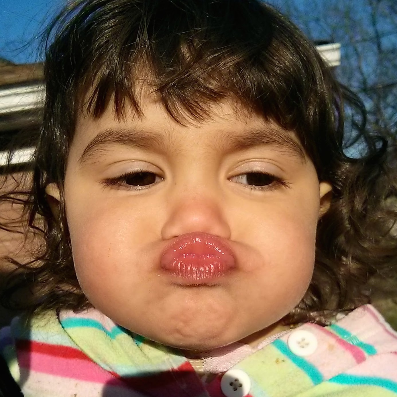 This is Emiliana Rascon, making a duckface because her father Otto has taught her the word “kiss” by making duckfaces at her. ” photo cred: Otto Rascon. “ - image